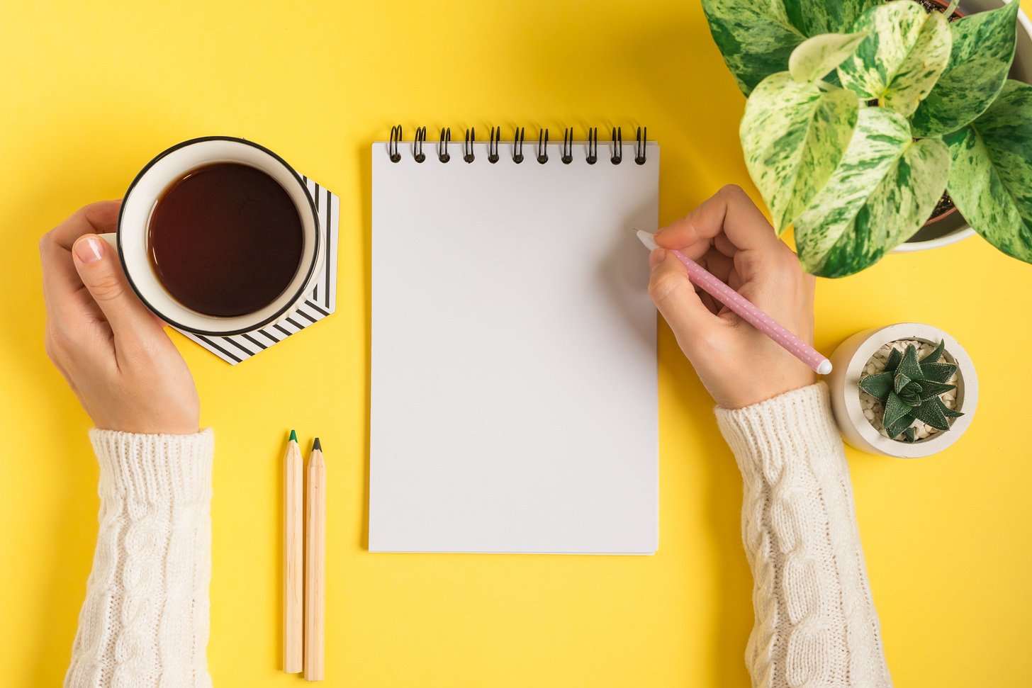 Woman hands writing in blank notepad.